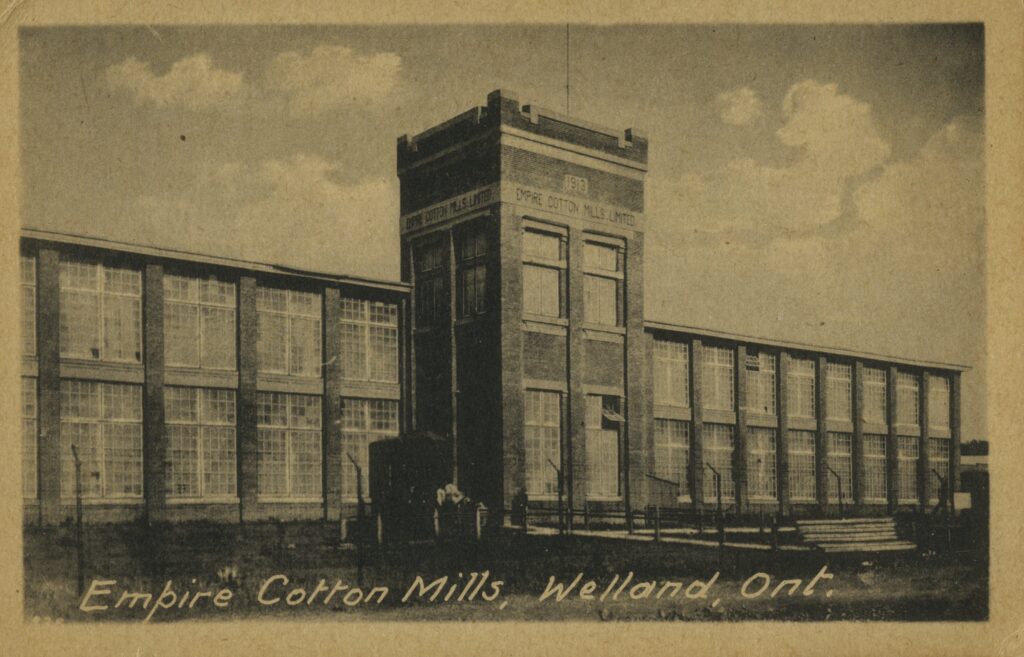 An old photo of a building. Hand printed at the bottom is "Empire Cotton Mills, Welland, Ontario."