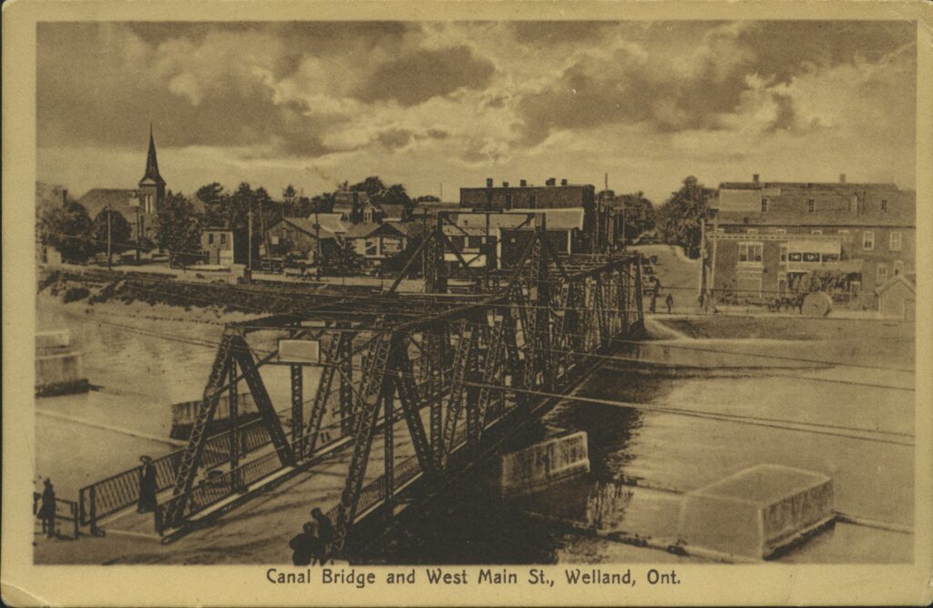 An old photo of the canal bridge over the water on West Main street in Welland, in the early 1900s.