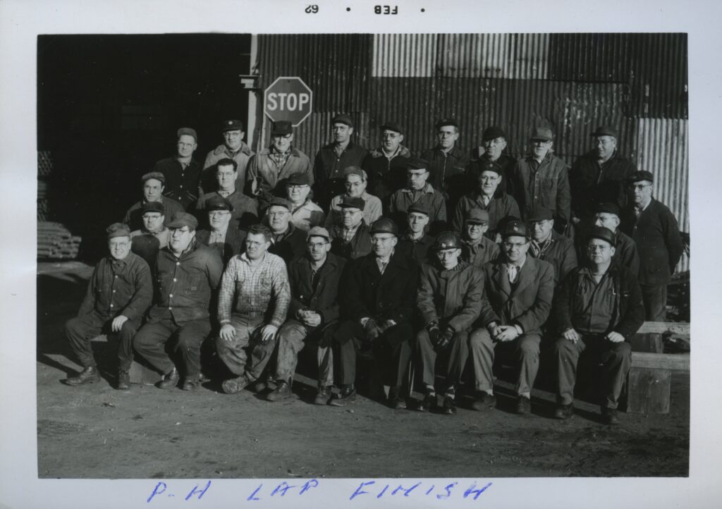 Four rows of men pose for a picture.