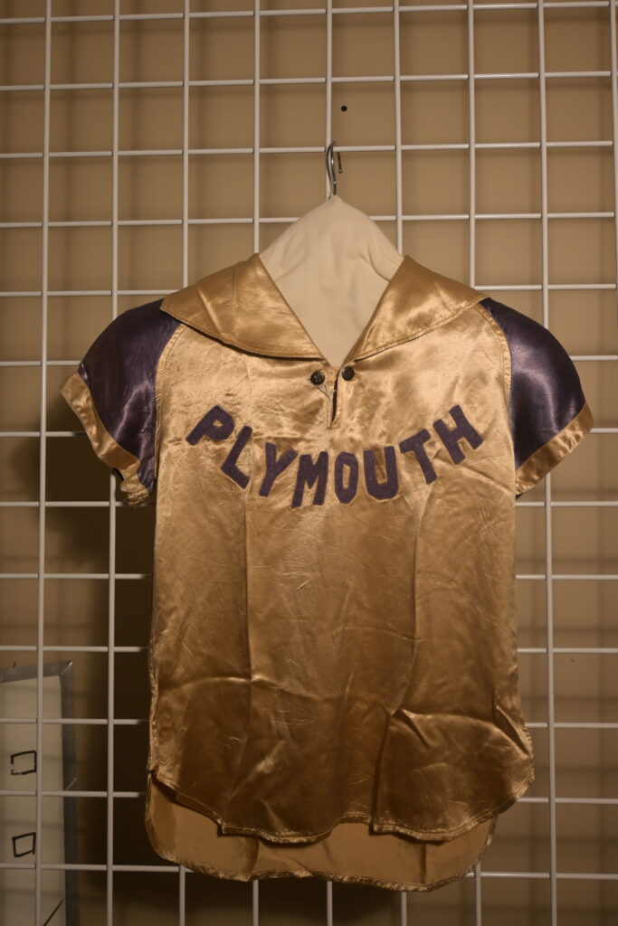 A jersey that says "PLYMOUTH" across the front. The material is golden-brown and shiny.